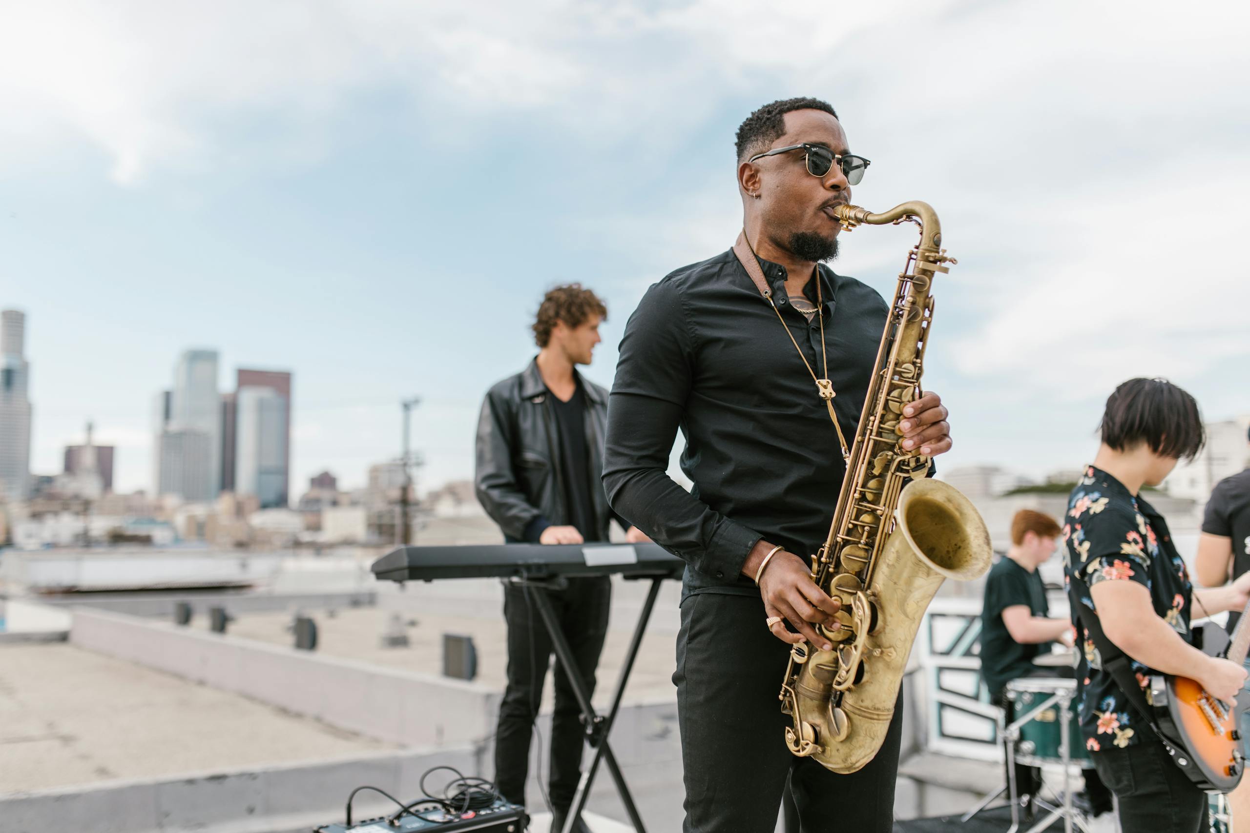 A vibrant outdoor performance by a jazz band on a rooftop featuring a saxophonist.